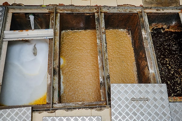 regular grease trap maintenance helps to prevent clogs and backups in your plumbing system